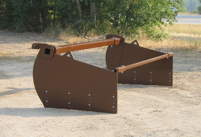 spreader for grading railroad ballast rock